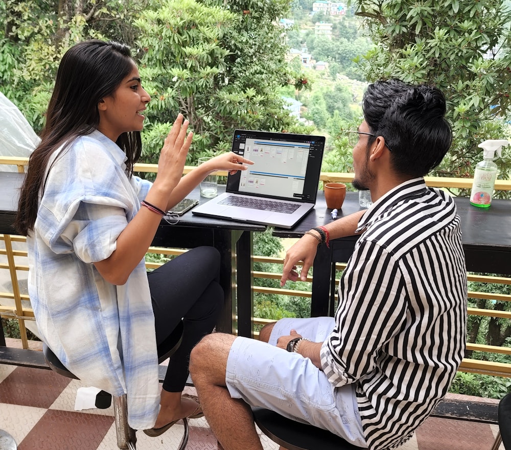 Team members collaborating over a laptop